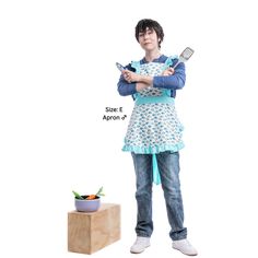 a woman standing next to a potted plant holding a spatula