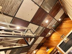 an overhead view of a room with wooden walls and metal ceiling tiles on the wall