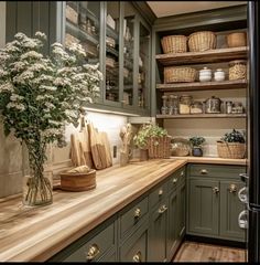 Hickory Cabinets Butcher Block Counter, Modern Farmhouse Green Kitchen, Green Kitchen Wooden Countertop, Kitchen Inspo Butcher Block, Wooden Kitchen Aesthetic, White Uppers Green Lowers, Cottagecore Interior Design Kitchen, Green And Butcher Block Kitchen, English Cottage Cabinets