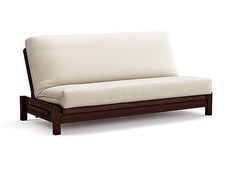 a white couch sitting on top of a wooden frame