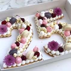 the number 20 is made out of cookies and decorated with icing, flowers, and seashells