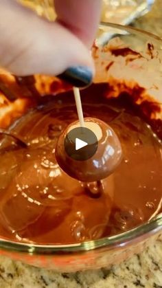 a person is dipping chocolate into a bowl