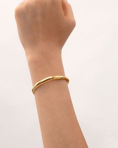 This bracelet features a classic bangle touched by the inspiration of life’s ups and downs, finished with a wavy shape that is concise and easy, encouraging people that - feel the changes and embrace them with no fear anymore. Classic silhouettes with wavy detailing give this ring versatility, ideal for stacking with other bracelets and jewelry in “The Wavy” collection or just worn solo.   Band Width: 6mm Band Thickness: 2.5mm Material: 18k Gold Plated On Brass Classic Bangle Bracelets For Friendship, Classic Friendship Bangle Bracelets, Everyday Bangle Bracelets, Gold Minimalist Cuff Bracelet For Friendship, Minimalist Open Cuff Bangle For Everyday, Everyday Polished Cuff Bangle, Everyday Minimalist Open Cuff Bracelet, Classic Everyday Cuff Bracelet With Oyster Design, Minimalist Yellow Gold Cuff Bracelets