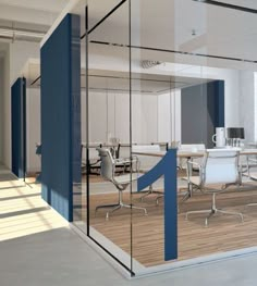 an office with glass walls and white desks