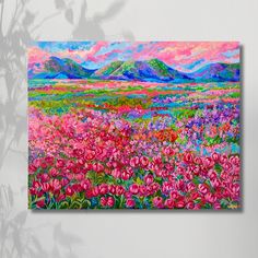 a painting on the wall of a field with pink flowers and mountains in the background