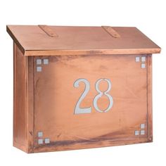 a wooden mailbox with the number 28 on it's front and side panels