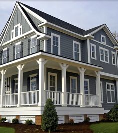 a large gray and white house with porches