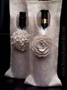 two wine bottles in bags with flowers on them