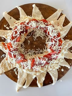 tortilla shells with sauce and cheese arranged in the shape of a sunflower