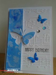 a birthday card with blue butterflies and music notes