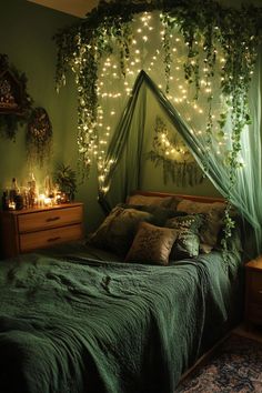 a bed with green sheets and lights on the headboard, in front of a window