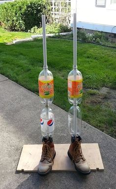 there are two bottles that have been placed on top of each other in front of a house