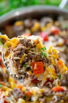 a spoon full of rice and vegetables with the words 30 minute beef and rice skillet