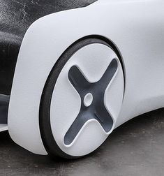 an electric car is shown with wheels and spokes on the front wheel, which are black and white