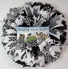 a black and white wreath with a book hanging on it