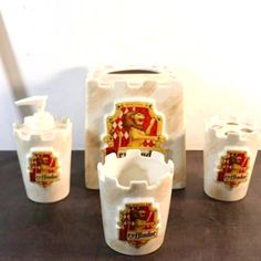 a set of five white ceramic containers on a table