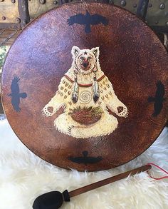 a bear is sitting on top of a wooden plate with an arrow in the middle