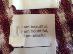 a piece of paper that has been pinned to a fabric with words written on it