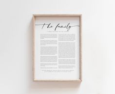 a framed poster with the family definition in black ink on white paper next to a plant