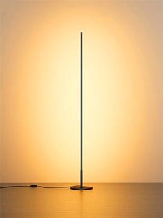 a lamp that is on top of a table in front of a light orange background