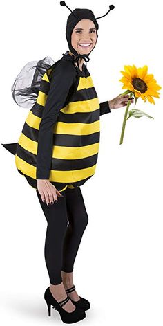 a woman in a bee costume holding a sunflower