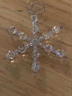 a snowflake ornament sitting on top of a wooden table