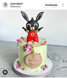 a cake decorated with a rabbit on top of it