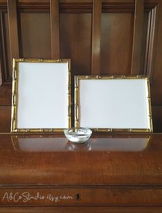 two empty frames sitting on top of a piano