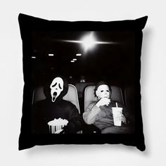 two people sitting in the back seat of a car with masks on their faces and one holding a drink