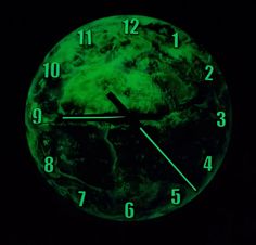 a clock that is glowing green in the dark