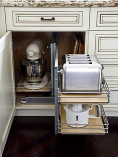 an open cabinet in the middle of a kitchen