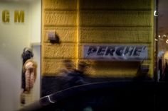 a motorcycle parked in front of a building with the word perche on it's side