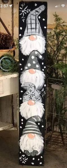 a snowboard decorated with santa claus faces