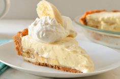 a piece of pie with whipped cream and bananas on top is sitting on a plate