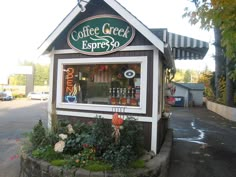 a small coffee shop sitting on the side of a road