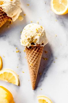 two scoops of fresh lemon ice cream sitting on top of a marble countertop