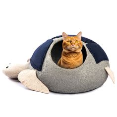 a cat sitting in a turtle shaped bed