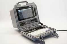 an old fashioned computer sitting on top of a white table