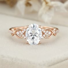 a rose gold engagement ring with an oval cut diamond