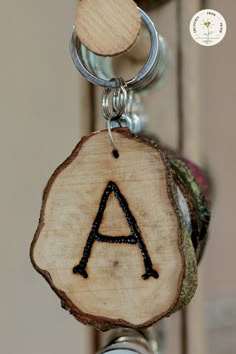 a wooden keychain with an initial on it