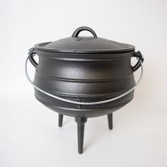 a black pot sitting on top of a white table