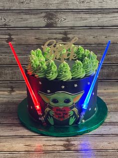 a star wars themed birthday cake with lights on and the child's name is made to look like yoda