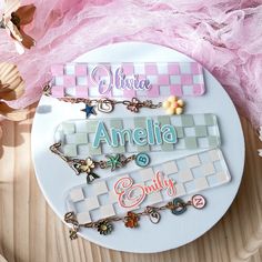 the name plate is decorated with charms and other personalized items, including bracelets