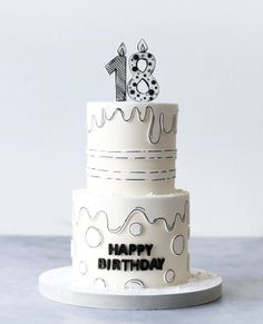 a three tiered birthday cake with the number one on it's frosting