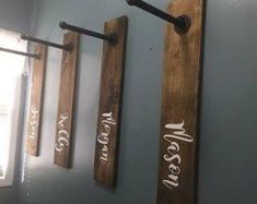 three wooden signs mounted to the side of a wall next to a window in a bathroom