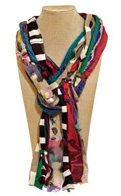 a multicolored scarf is displayed on a mannequin