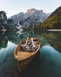 a person sitting in a boat on the water