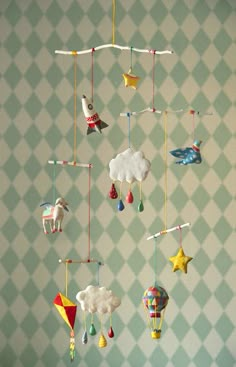 a mobile made out of paper with animals and hot air balloons hanging from it