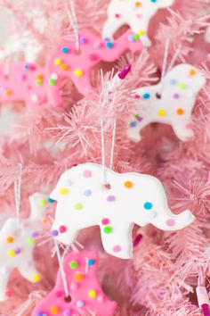 pink christmas tree decorated with white and multicolored elephant ornament ornaments on them