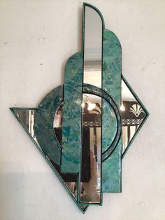 a decorative mirror mounted to the side of a wall